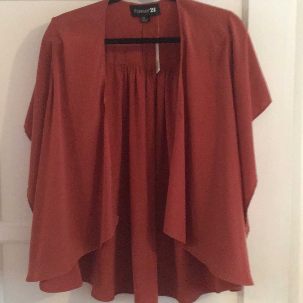 Fashion jacket in the color rust. Never been worn